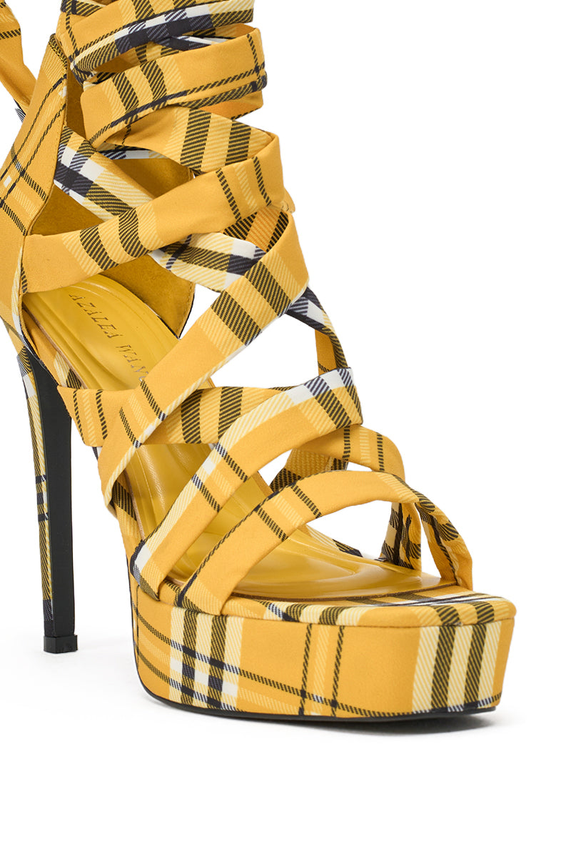 The AZALEA WANG JEMISHA YELLOW PLAID PLATFORM LACE UP SANDAL showcases a bold yellow plaid pattern, black and white stripes, a stiletto heel, and multiple crisscrossing lace-up straps for a striking, fashion-forward statement. 6