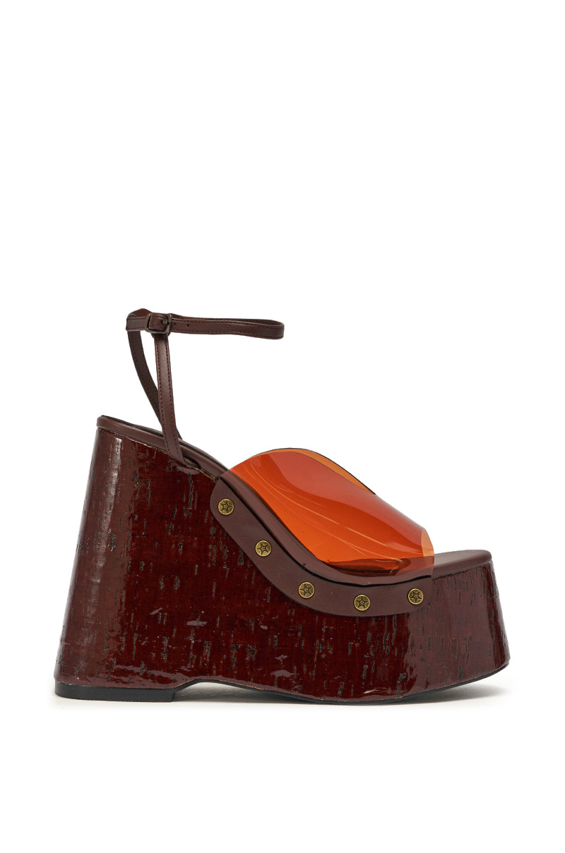 The AZALEA WANG JENZA CHOCOLATE WEDGE is a sandal with a chunky wood-textured chocolate platform heel, brown ankle strap, and an orange translucent upper detailed with gold rivets. 5