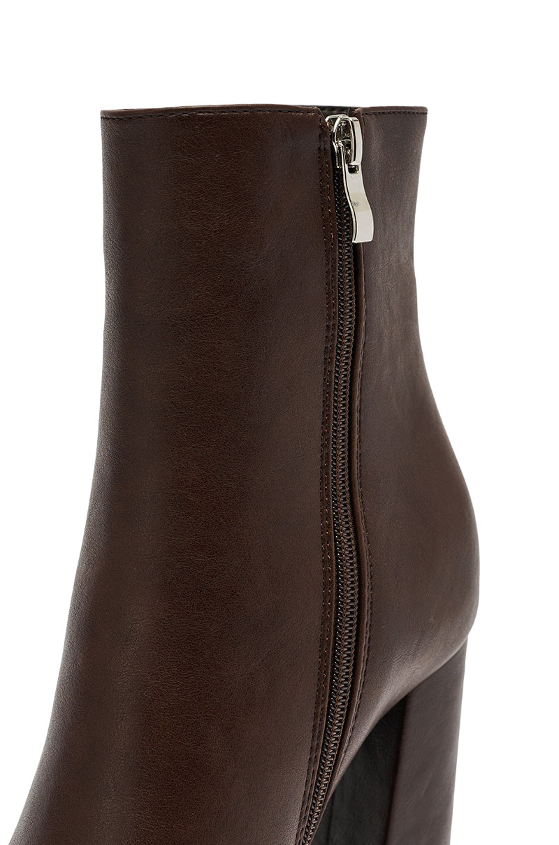 Close-up of the AZALEA WANG JESSABELL Brown Pointed Toe Bootie, featuring brown faux leather, a visible side zipper, and a chunky heel, displayed against a white background.