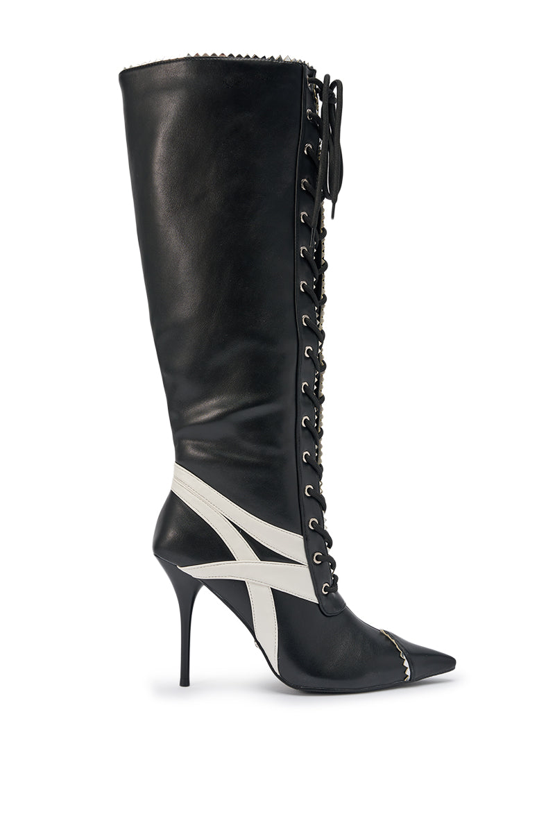The AZALEA WANG JETER BLACK SPORTY STILETTO BOOT features black faux leather, white diagonal stripes, front laces with gold eyelets, a pointed toe, and a knee-high stiletto design. 4
