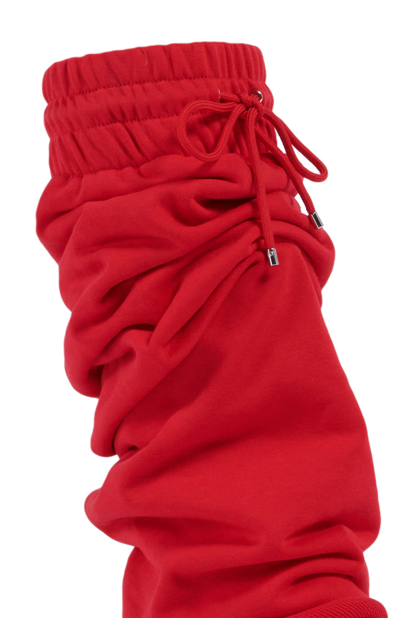 Close-up of the AZALEA WANG JETSETTER RED BOOT's scrunched fabric sleeve, featuring an adjustable drawstring at the top. The stretchy, sweatpant-inspired fabric appears soft and slightly gathered, creating a textured look.