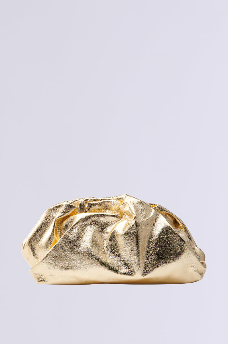 The OVER IT METALLIC CLUTCH, small and metallic with a textured surface akin to soft fabric, sits against a plain light gray background. Its gathered top adds volume and elegance. 0