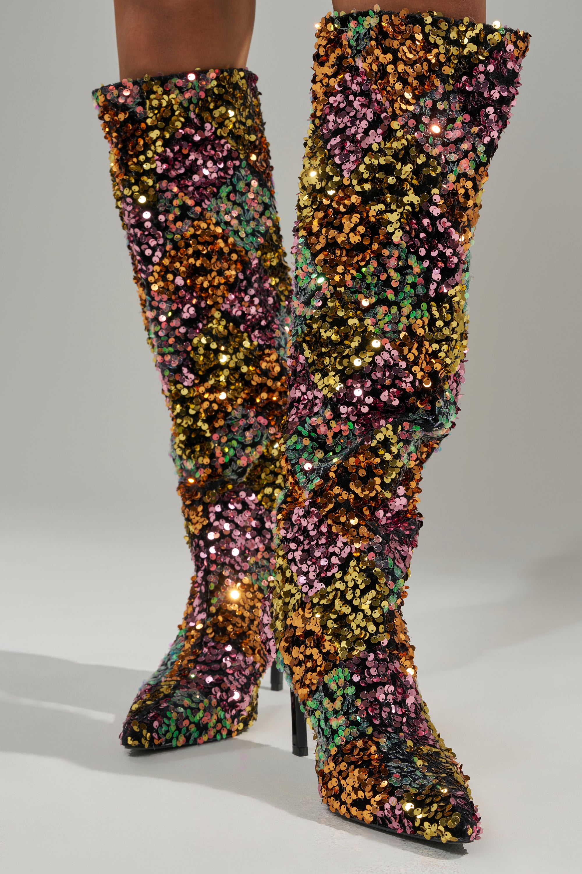 The AZALEA WANG JIMENA MULTI GOLD SEQUIN KNEE HIGH STILETTO BOOT dazzles with gold, pink, green, and purple sequins in a sparkling design—perfect for making a bold statement.