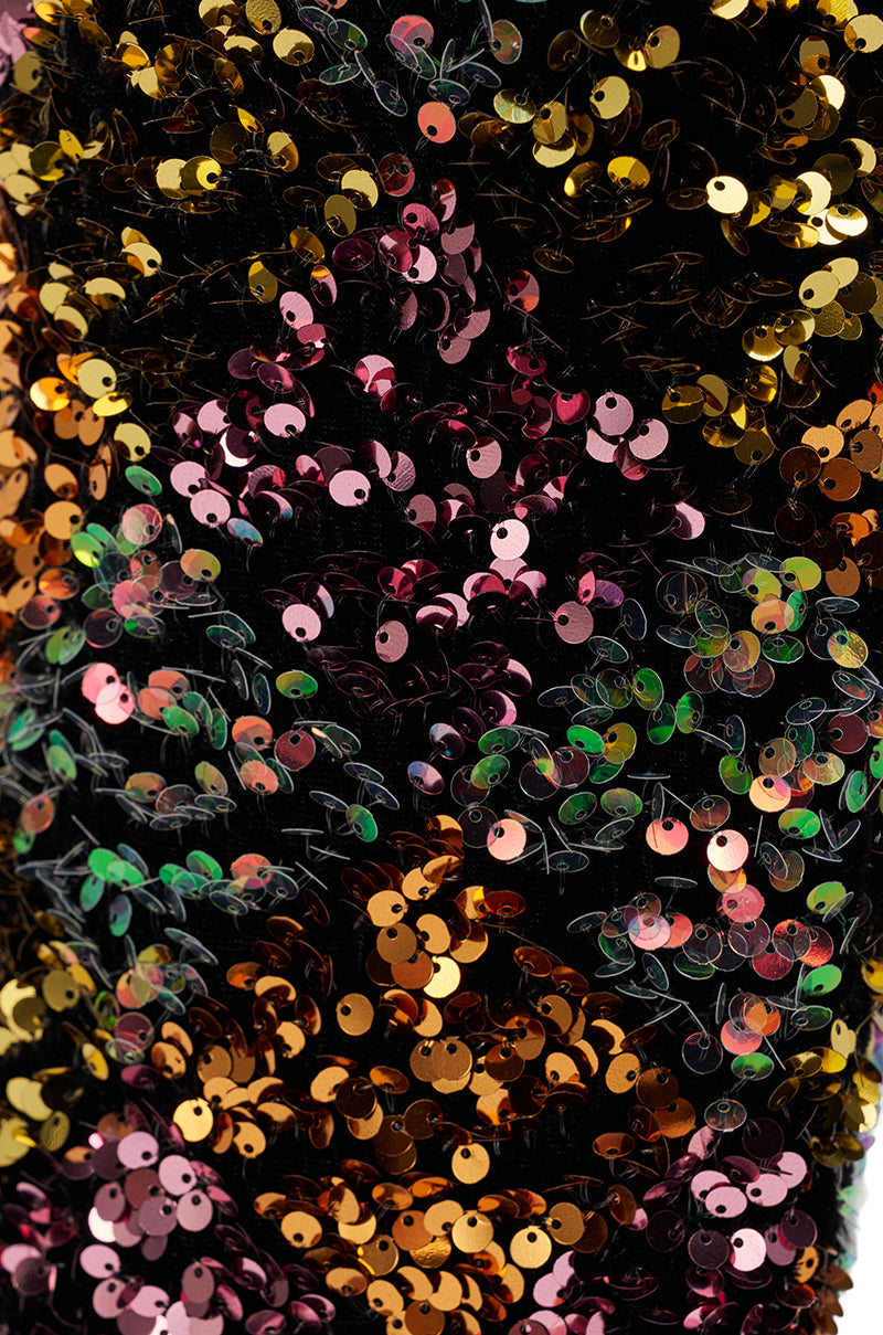 Close-up of densely packed, multicolored sequins on black fabric, reflecting gold, pink, green, and purple—evoking the dazzling shimmer of the AZALEA WANG JIMENA MULTI GOLD SEQUIN KNEE HIGH STILETTO BOOT.