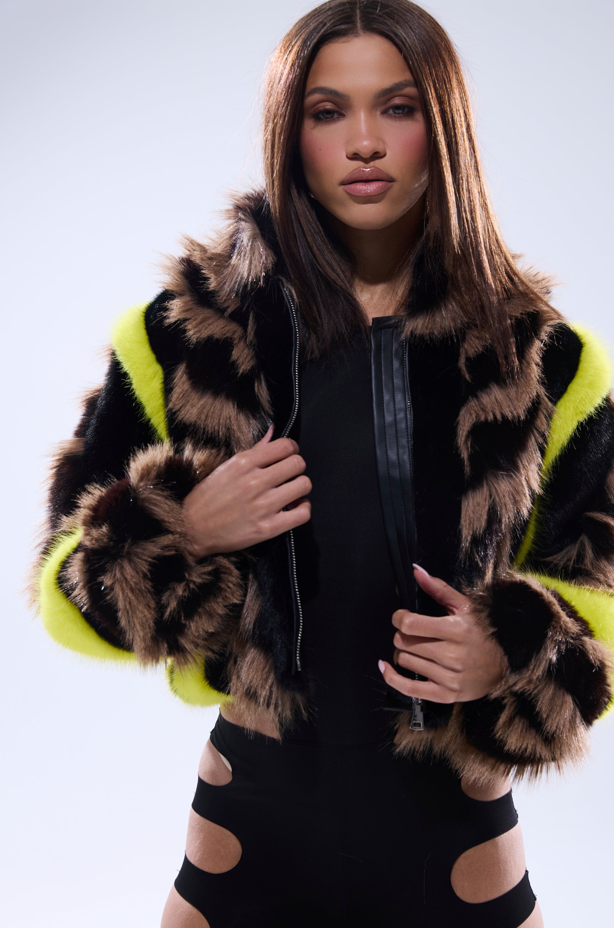 A woman in the MISS ME WITH THAT PANELED FAUX FUR coat.