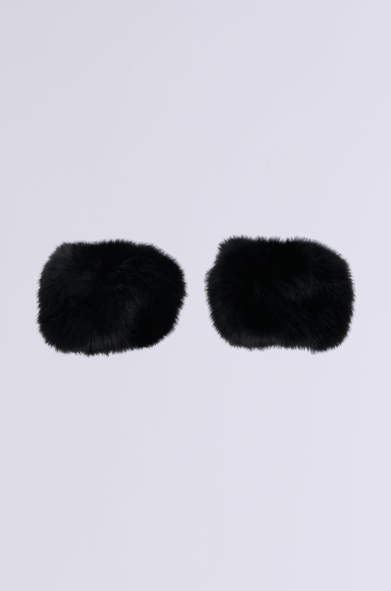 The STAYING WARM FAUX FUR CUFFS earmuffs, an ideal winter accessory, stand out against a simple light gray background. These black, fluffy earmuffs feature faux fur cuffs and offer an adjustable fit for maximum comfort.