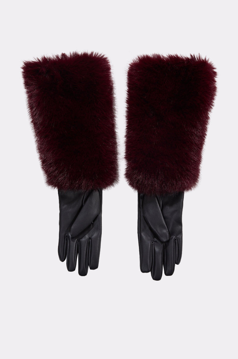 The ALAIA FAUX FUR GLOVES are black leather, elbow-length gloves with plum faux fur cuffs, shown laid flat on a light background. 2