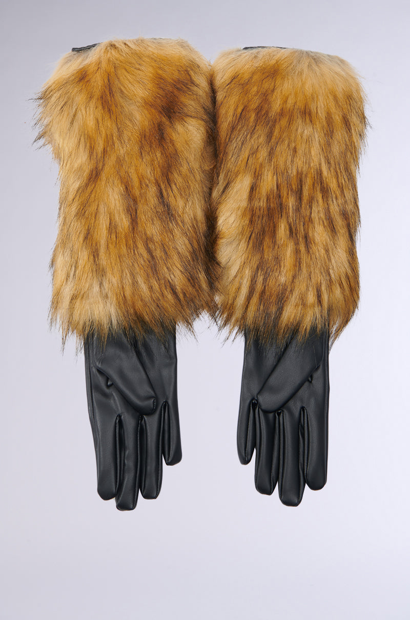Introducing the GRACELLE EXTENDED FAUX FUR GLOVES, showcasing a stylish combination of black leather fingers and brown faux fur cuffs. These elegant gloves make an ideal winter accessory, beautifully presented against a light gray background. 3