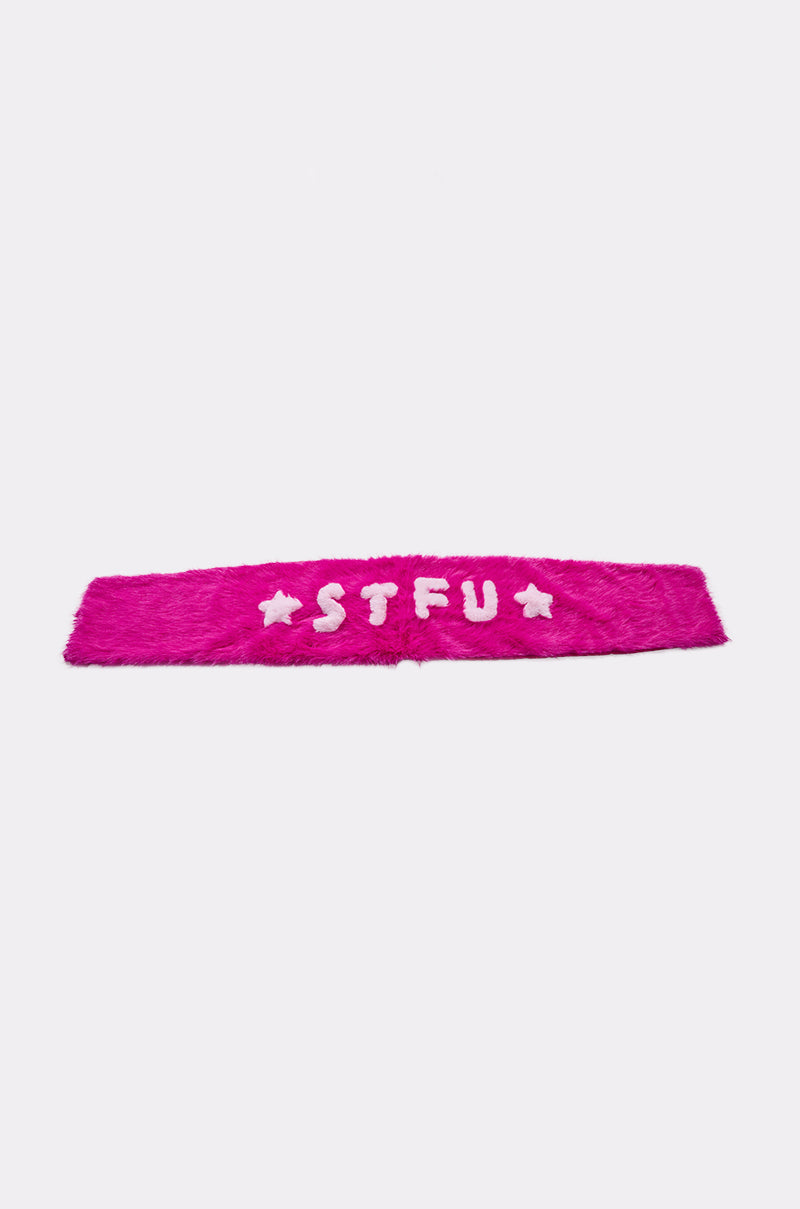 The STFU FAUX FUR SCARF features bold pink faux fur with white "STFU" lettering and two white stars, making it a standout accessory that's eye-catching and perfect for adding attitude to your look. Displayed on a plain white background. 7