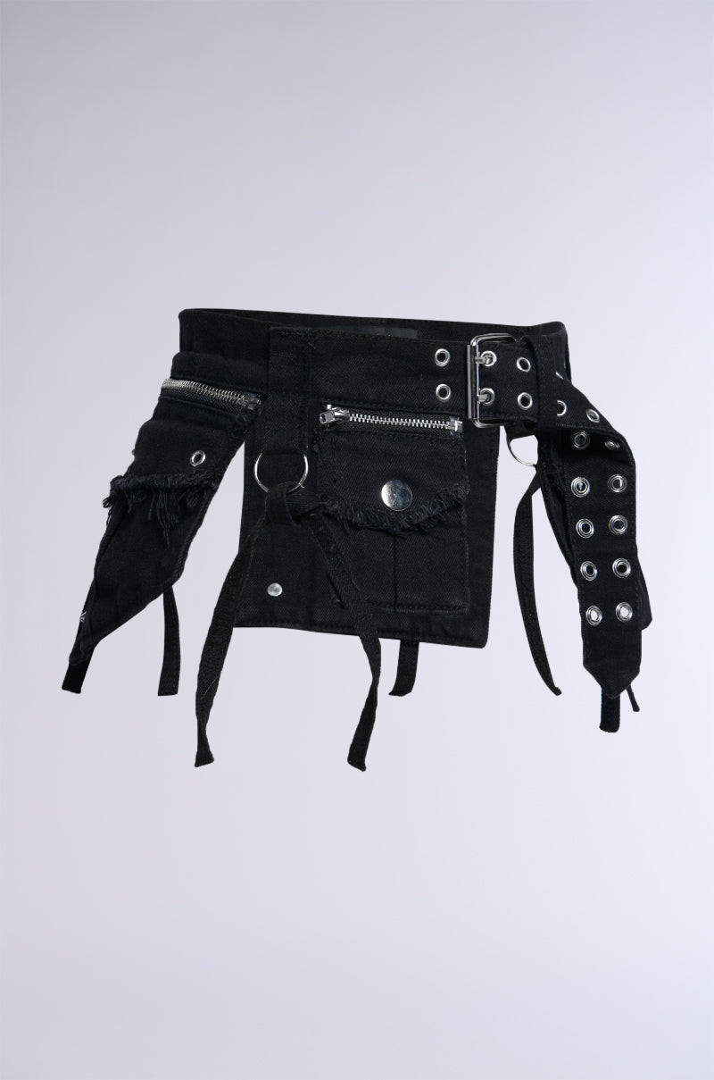 Introducing the STICK WITH THE TRENDS UTILITY BELT: a black fabric belt designed with multiple cargo pockets and frayed edges. It features zippers, a large metal snap button, and faux silver metallic hardware for an adjustable fit. The belt is adorned with straps and loops hanging from various sections, enhancing its rugged and utilitarian design.