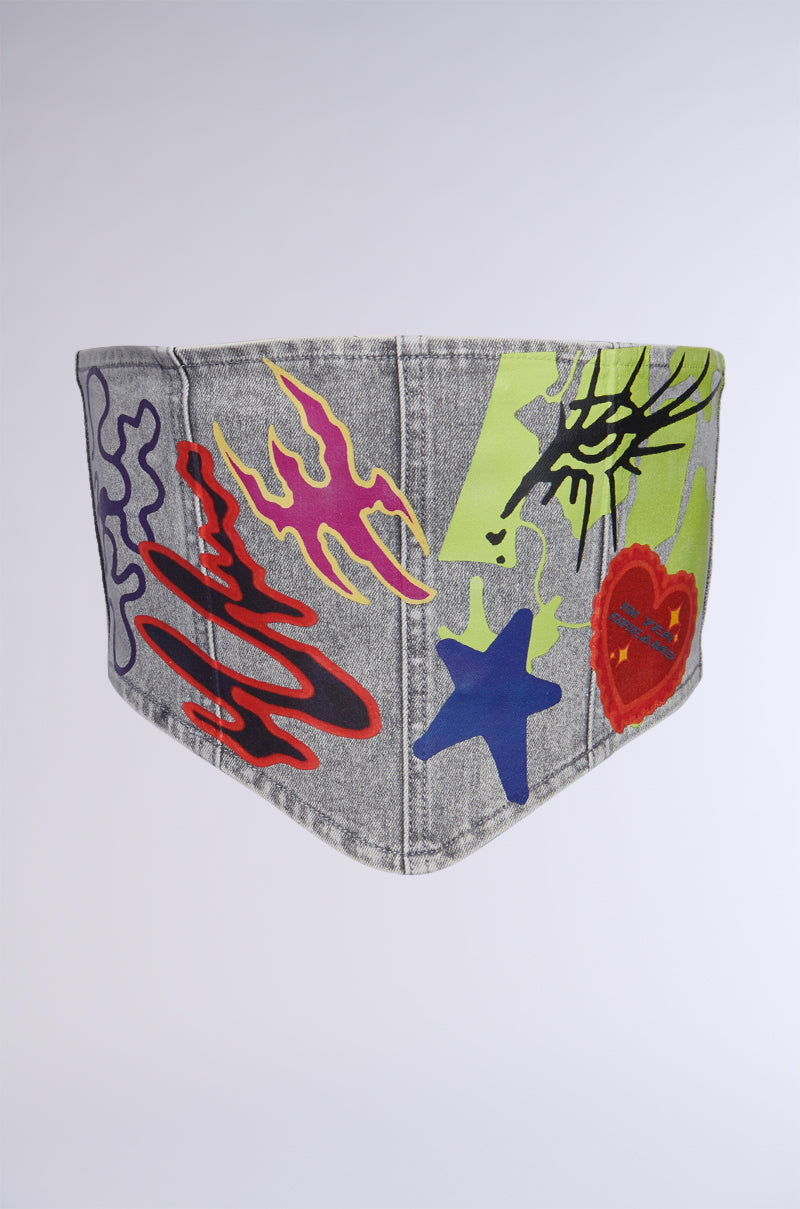 The PATCHED UP STRETCH DENIM BELT showcases streetwear-inspired, graffiti-style artwork with vibrant abstract designs, featuring red and purple squiggles, blue and purple stars, and a red heart set against a gray backdrop. 2