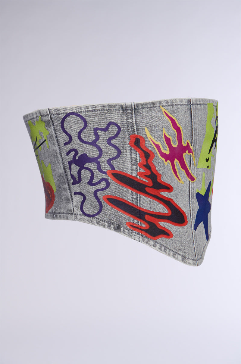 The PATCHED UP STRETCH DENIM BELT displays streetwear-inspired and graffiti-style graphics with colorful abstract designs, including red and yellow flame-like shapes, purple squiggles, green patches, and blue stars set against a plain background. 3