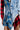 The PATCHWORK PLAID DENIM MINI DRESS showcases a punk-inspired look with mixed textiles like denim and blue-red plaid. It features buttons, frayed edges, and an asymmetric design that blends jacket and skirt elements for a bold statement.