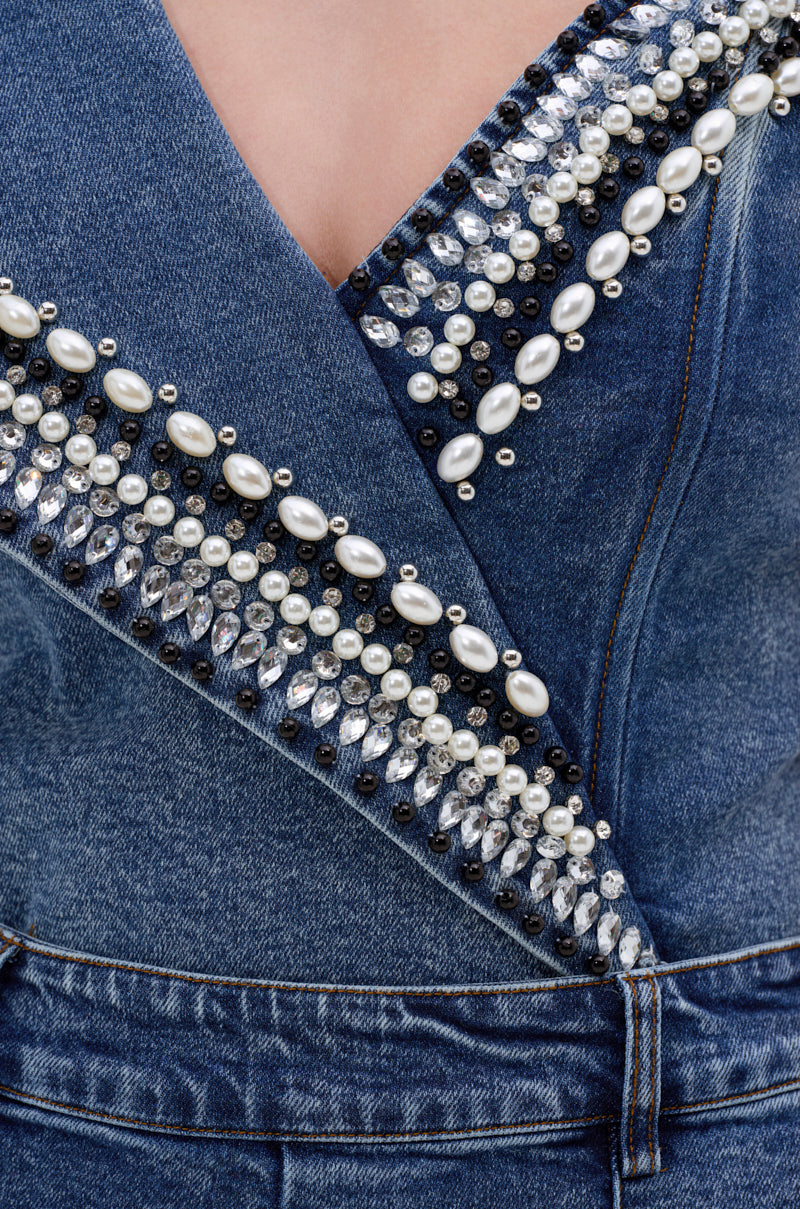 Close-up of the LUXURIOUS DENIM ASYMMETRICAL PEARL BODYSUIT, featuring a deep V-neck and embellished with pearls, rhinestones, and beads in unique shapes—creating sparkling asymmetrical pearl accents for a standout look.