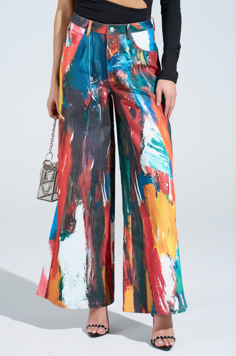 With CREATIVE FREEDOM PRINTED DENIM, flaunt an artistic vibe. Pair these high-rise wide-leg jeans with a colorful abstract pattern with a black long-sleeve top, and accessorize with a small textured handbag and black studded sandals.