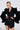 Exuding luxury, the individual poses confidently in the 