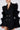 Wearing the LIVING OVER THE TOP RUFFLE SLEEVE BLAZER MINI DRESS in chic black with gold buttons, paired with large colorful earrings, offers a luxurious and fashionable ensemble ideal for formal events.