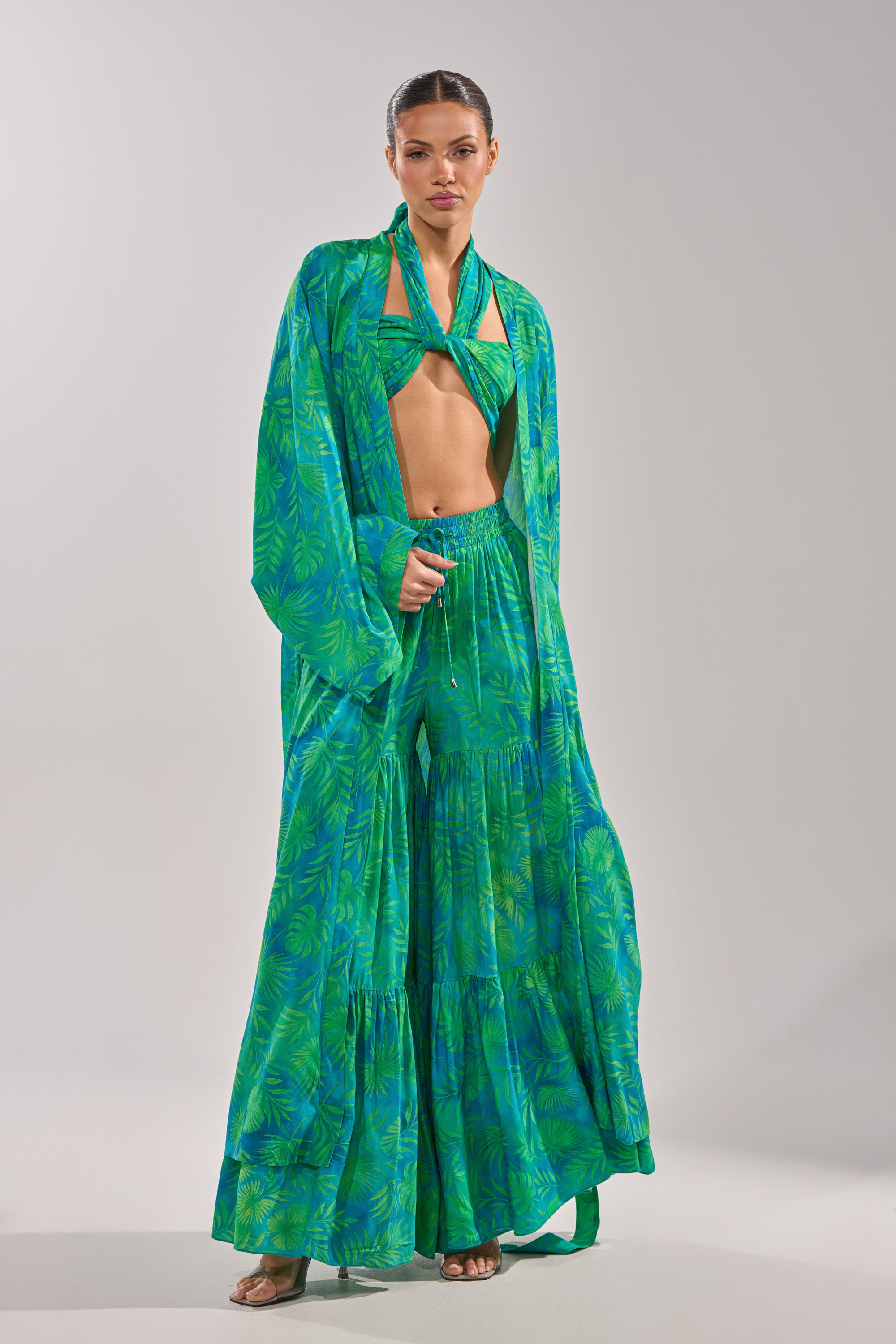 A woman wearing the INTO THE GARDEN DUSTER IN GREEN, featuring a botanical pattern. 4