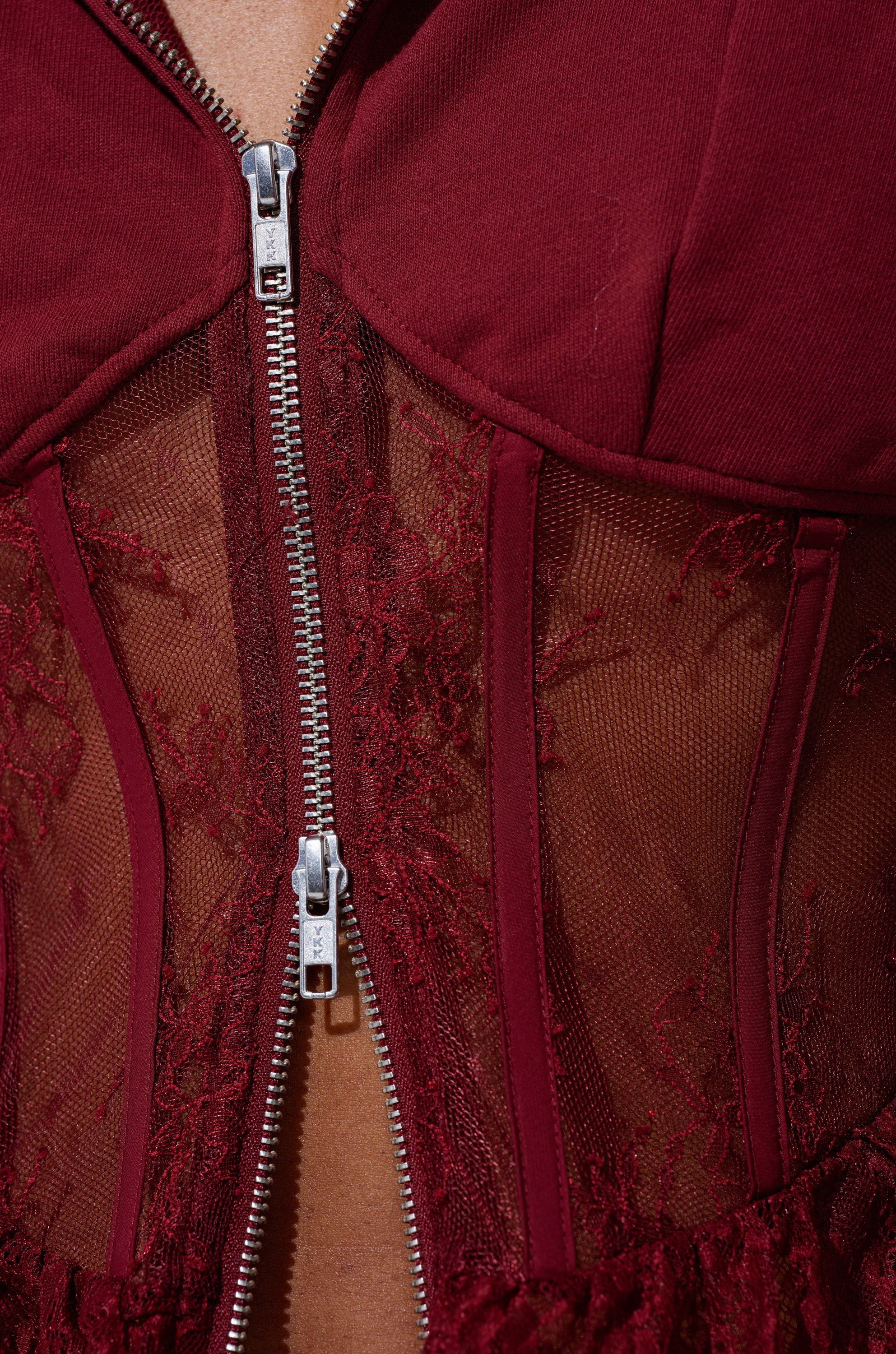 Close-up of the TOO TRENDY ZIP UP SWEATSHIRT WITH LACE in rich burgundy, featuring sheer mesh, lace panels, and textured fabric for a stylish and unique cropped hoodie look.