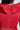 A person with long dark hair is shown from the back wearing the MISS FASHIONISTA SLEEVELESS RUFFLE PEPLUM BLOUSE IN RED, featuring a visible middle zipper and a slight sheen cotton blend fabric. A large collar detail is partially visible at the top.