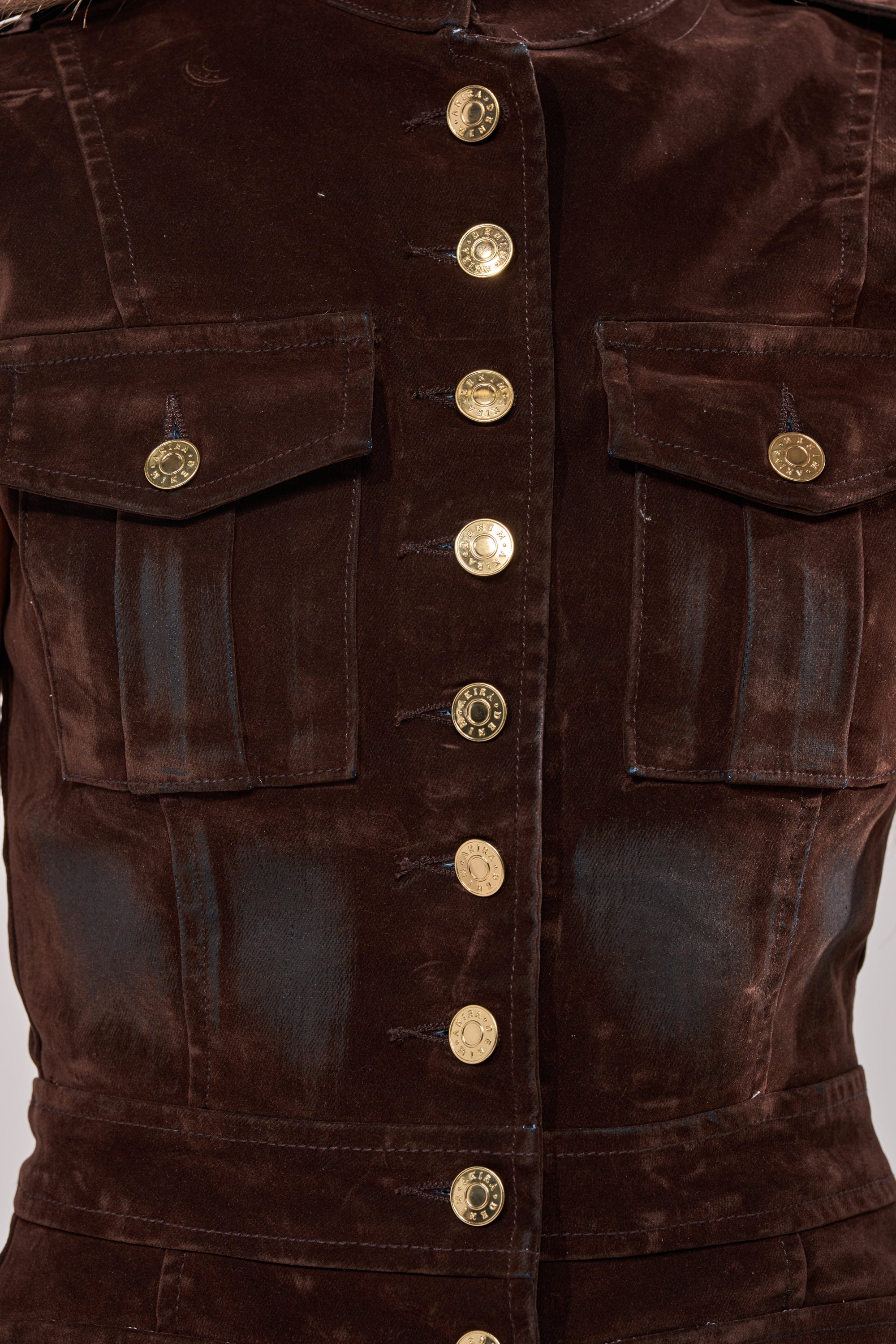 Close-up of the BACK WITH IT VELVET BUTTON DOWN, a dark brown fitted military-style vest jacket featuring two chest pockets and a single row of shiny gold buttons.