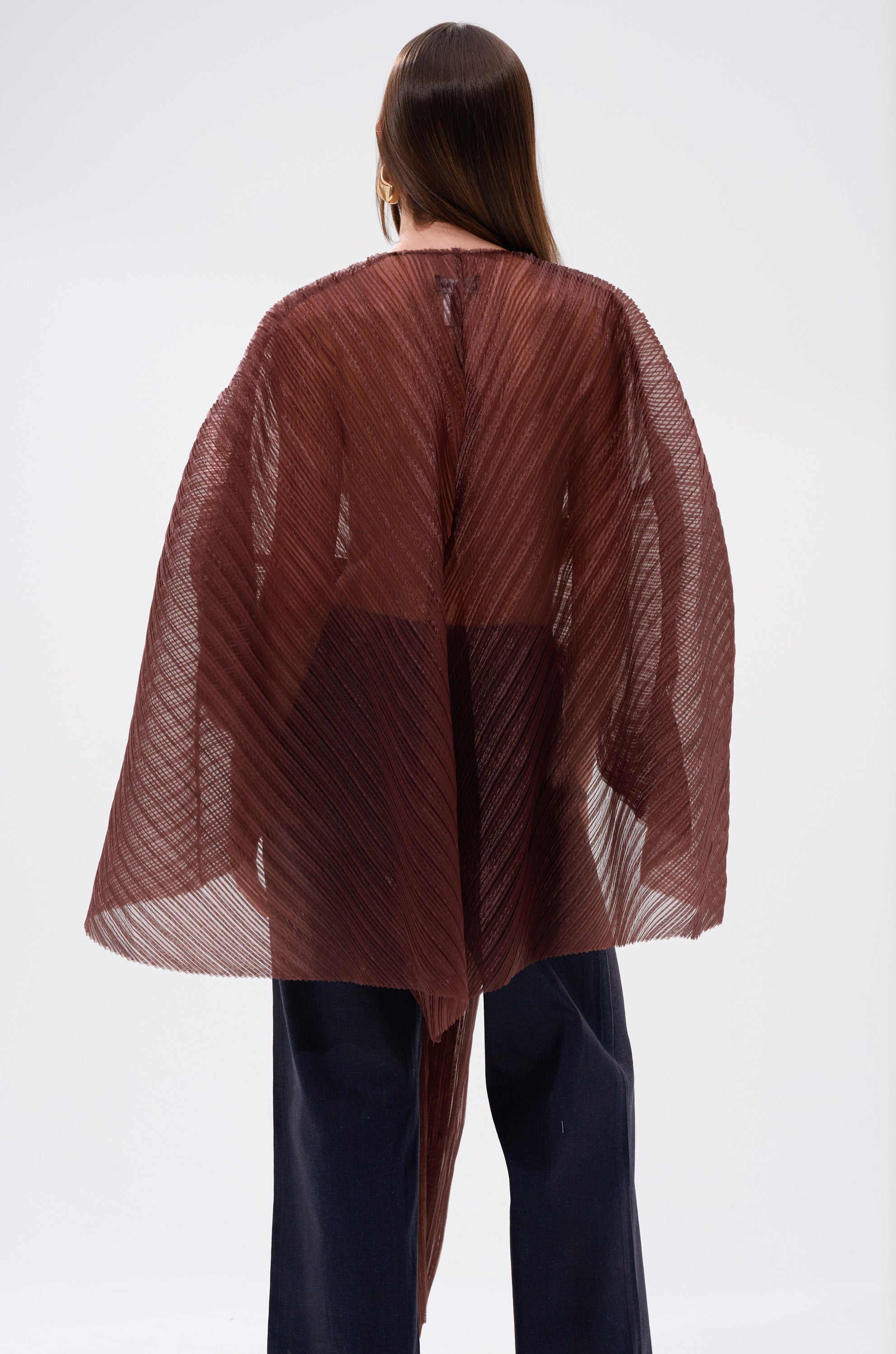 A woman wearing the FLY AWAY WITH ME BLOUSE IN BRONZE, featuring batwing sleeves and an organza finish.