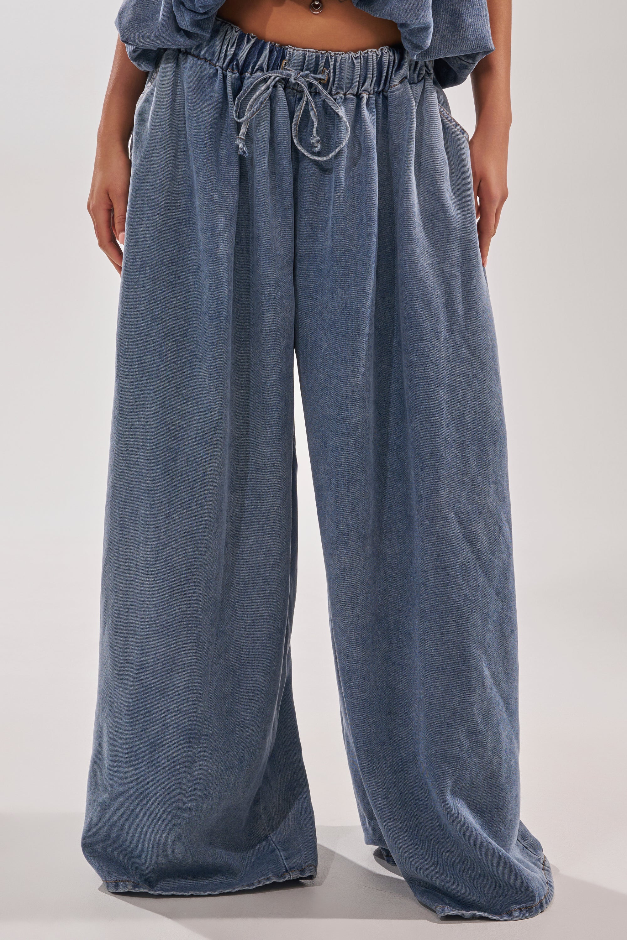 Wearing the DENIM FOR DAYS JOGGER, featuring a loose fit, high-rise cut, and elastic drawstring waistband; only the lower torso and legs are shown. 1