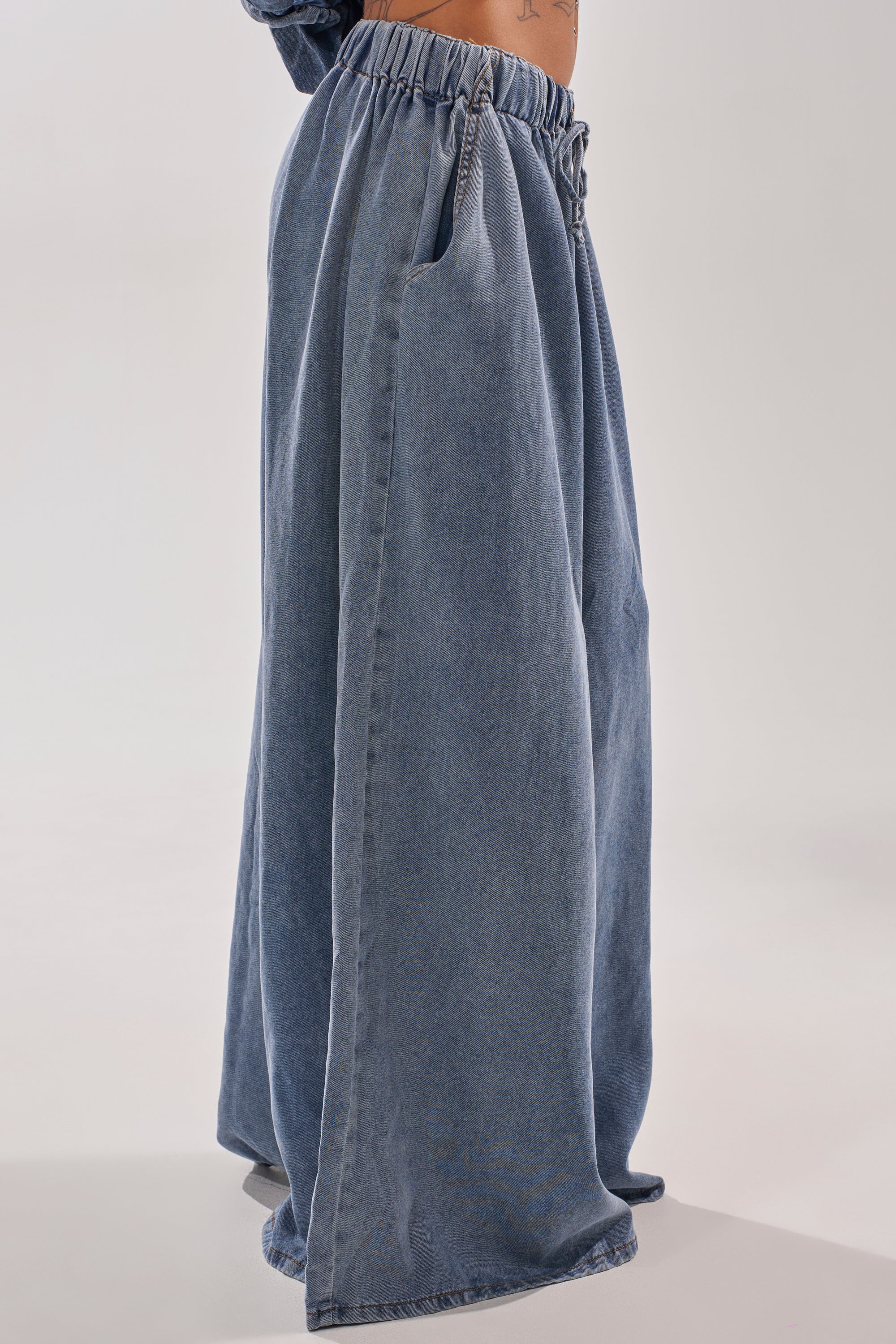 A person wearing the DENIM FOR DAYS JOGGER, featuring a high-rise fit with an elastic waistband and side pockets, stands against a plain light background. 3