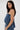 A woman with long dark hair wears the DENIM FOR DAYS TUBE TOP, featuring a drawstring neckline. She stands sideways against a white background, looking at the camera with a neutral expression and wearing hoop earrings.