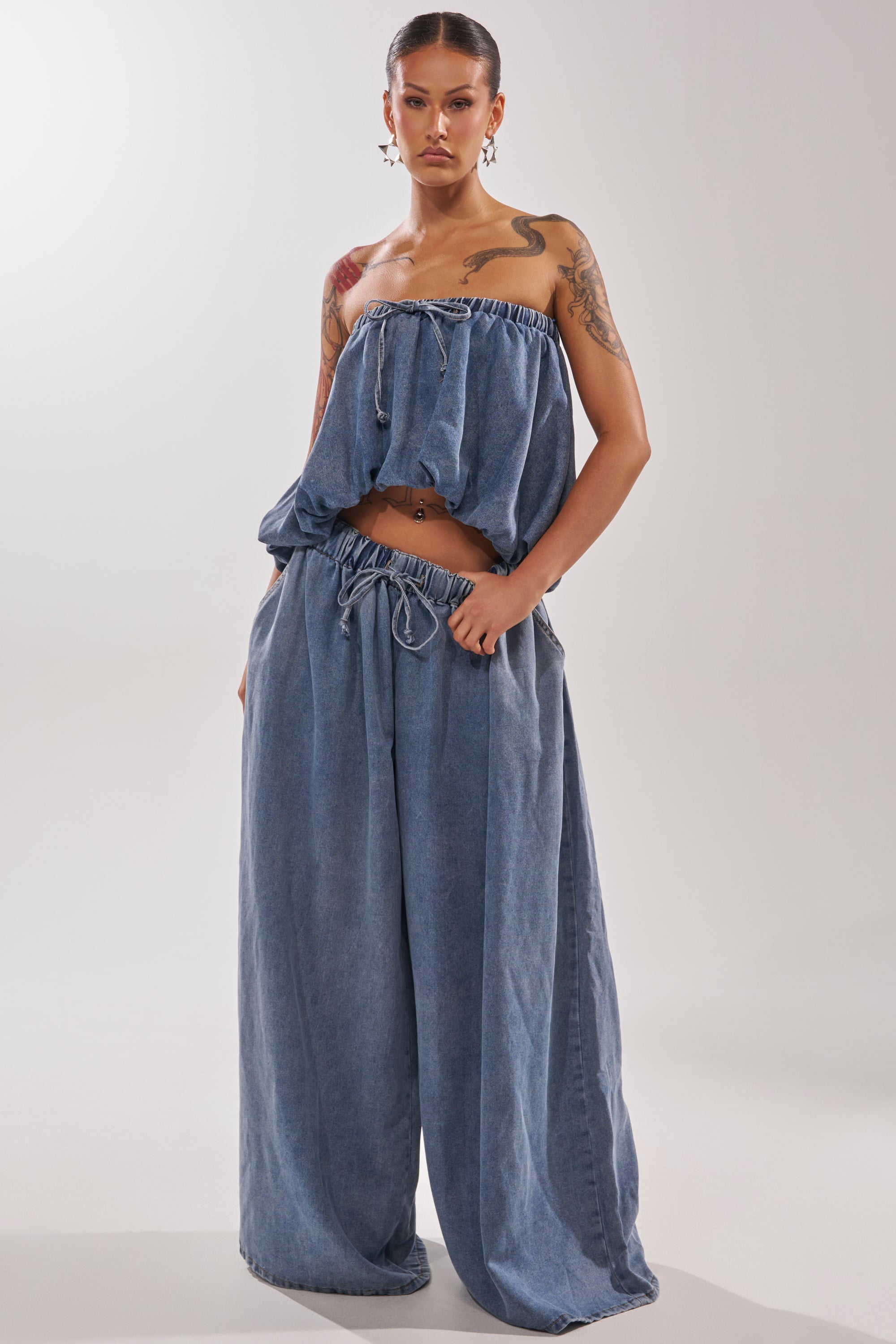 Wearing the DENIM FOR DAYS TUBE TOP with drawstrings and matching wide-leg denim pants, a person stands confidently against a plain light background, showcasing a relaxed summer-chic style. 4