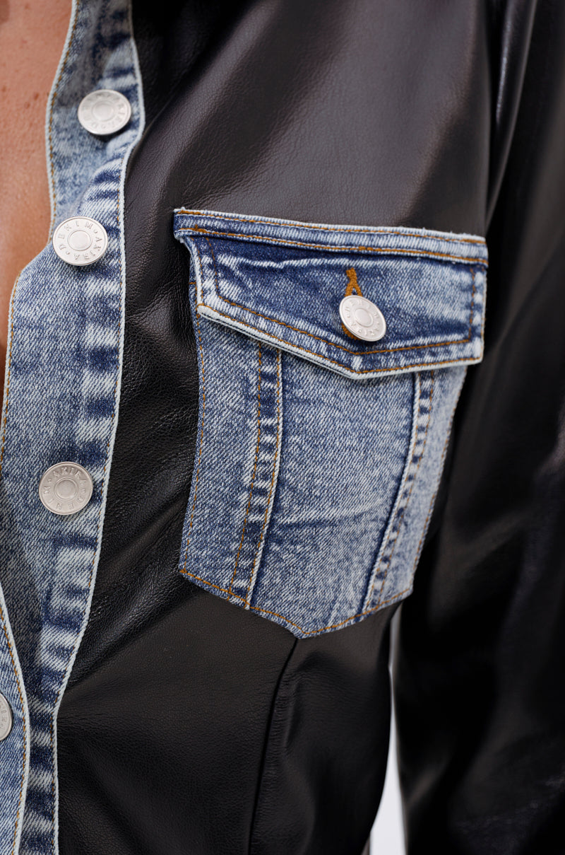 Close-up of the MIXED VIBES FAUX LEATHER BUTTON DOWN, a structured top with black faux leather, denim trim, large silver buttons, and a denim chest pocket featuring a flap and button accent for bold contrast. 8