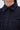 Close-up of the RUFFLED UP LONG SLEEVE DENIM TOP, featuring dark-wash denim with white stitching, two chest pockets, and fabric-covered buttons. The image highlights the collar, buttons, and upper pocket area.