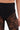 Close-up of a person wearing SUPER LACE STRETCHY LEGGINGS in high-rise fit. These semi-sheer black leggings feature floral lace on the legs, with an opaque waistband and upper portion. The background is plain white.