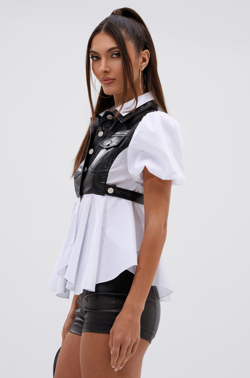 A woman with long, straight brown hair models the NEW DRESS CODE LEATHER AND POPLIN BUTTON DOWN SHIRT, standing sideways and looking at the camera with a neutral expression. 3
