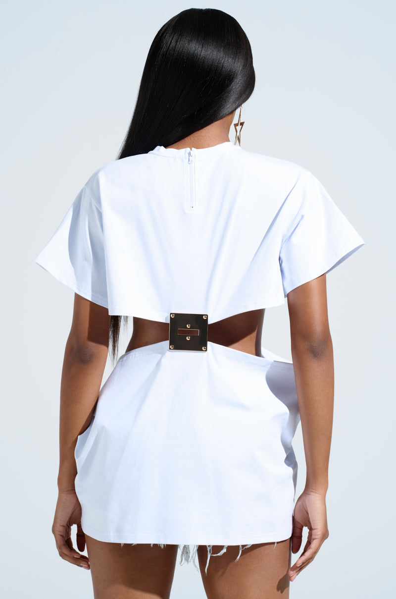 A person with long, straight hair is wearing the Girl Boss Moments Cut Out T-shirt in white, viewed from the back. The top exudes high-fashion drama with its unique cut-out design and square metal clasp at the waist. The sky provides a clear, light blue background.