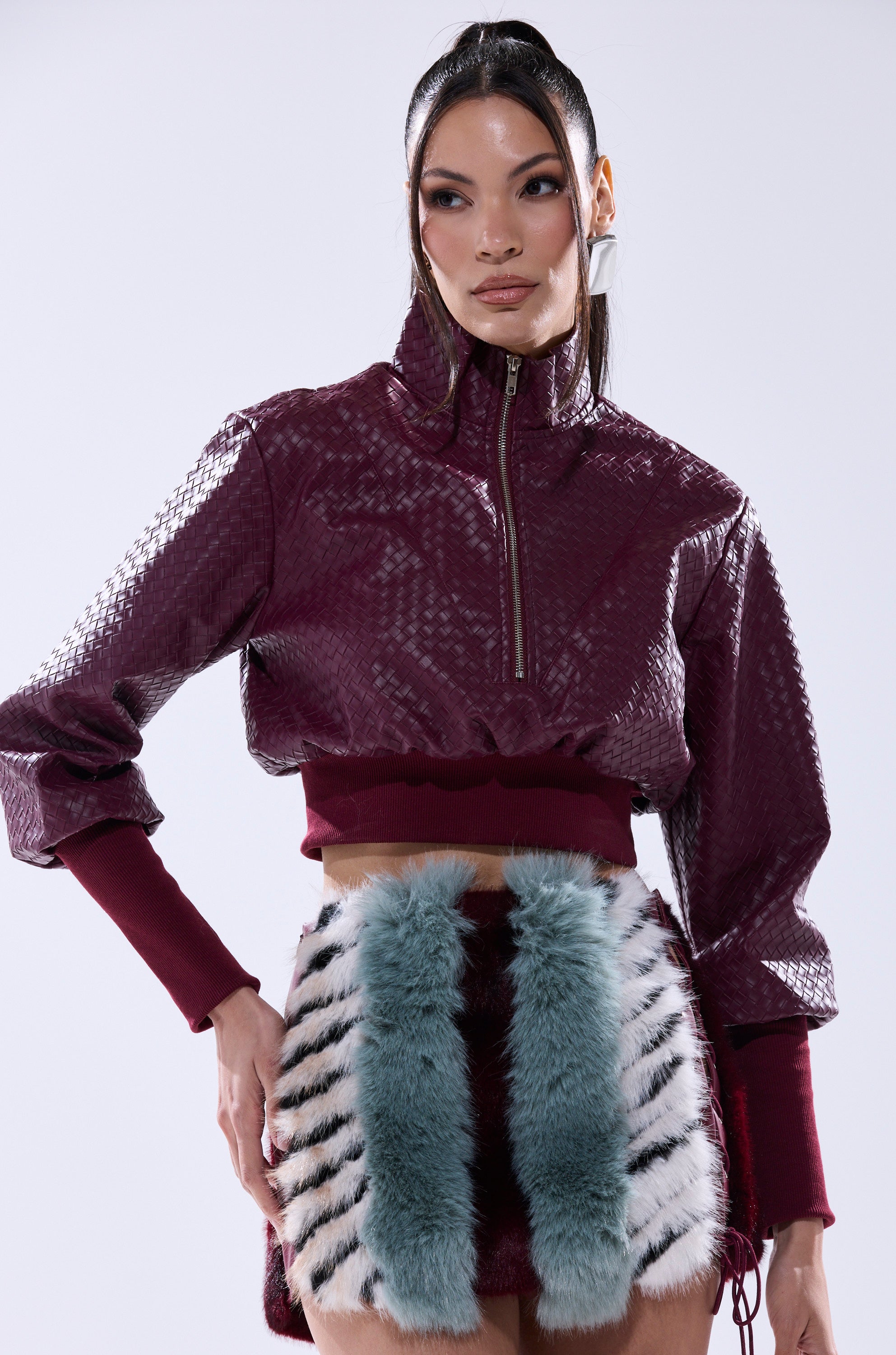 A woman in a purple VENETTA FAUX LEATHER QUARTER ZIP SWEATSHIRT.
