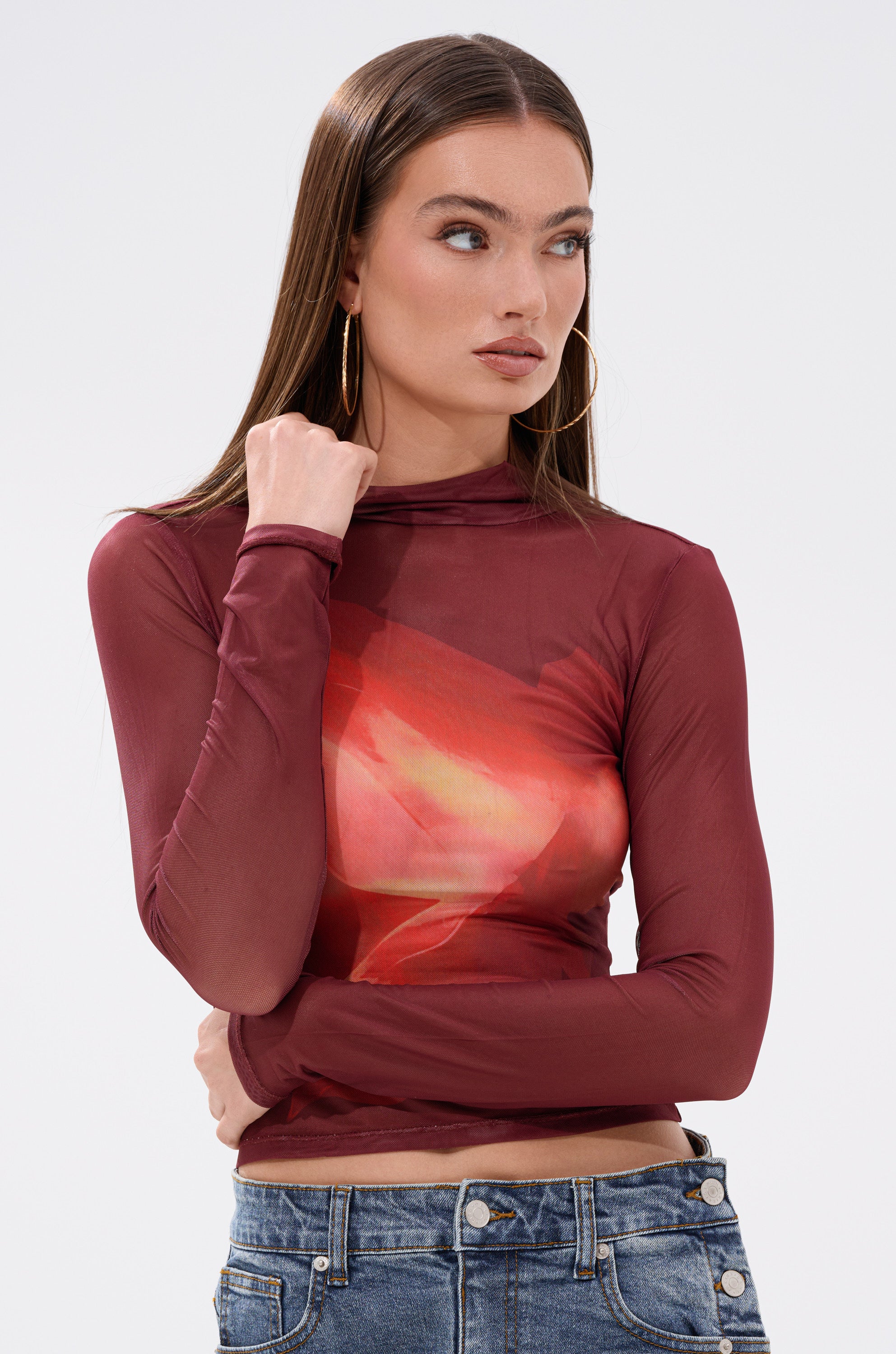A woman wearing the SUNSHINE LOVER MESH LONG SLEEVE top.
