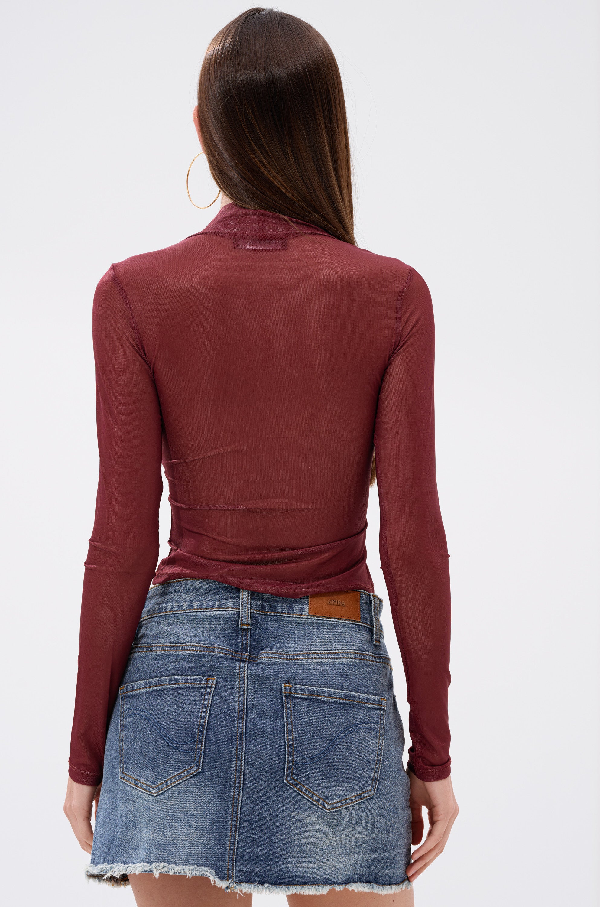 A woman wears the SUNSHINE LOVER MESH LONG SLEEVE, a red, curve-hugging fit top.