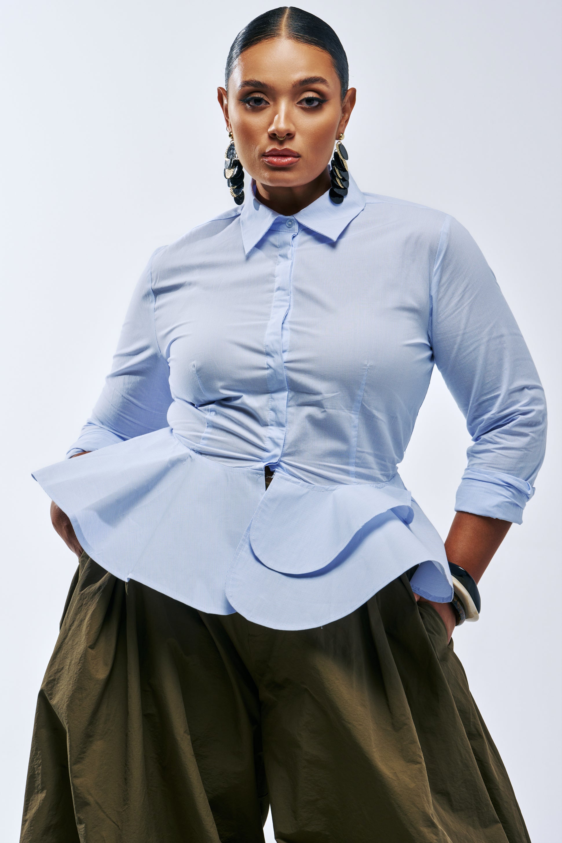 TOP OF MY GAME POPLIN BLOUSE in light blue pinstripe, styled with olive green wide-leg pants.
