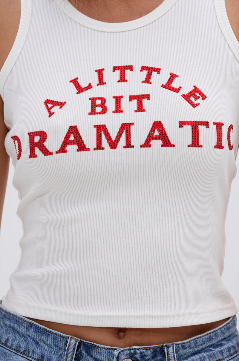 Someone wears the A LITTLE DRAMATIC EMBELLISHED TANK TOP—a white ribbed tank with bold red rhinestone letters—paired with blue jeans. 5