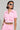A woman with short dark hair is wearing white sunglasses and the AKIRA Label 