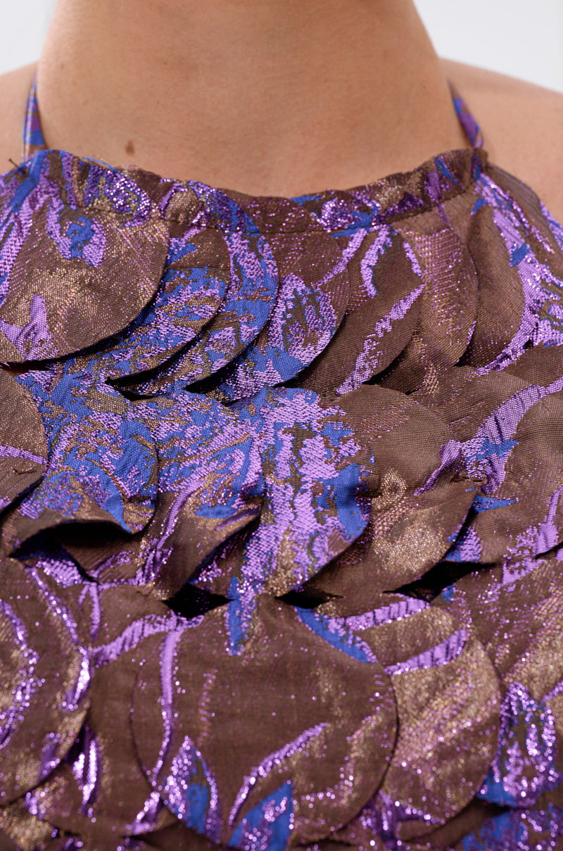 A close-up of the LIGHTS FLASHING BROCADE HALTER TIE NECK, featuring metallic brocade with overlapping brown and purple iridescent circles and abstract patterns. 6