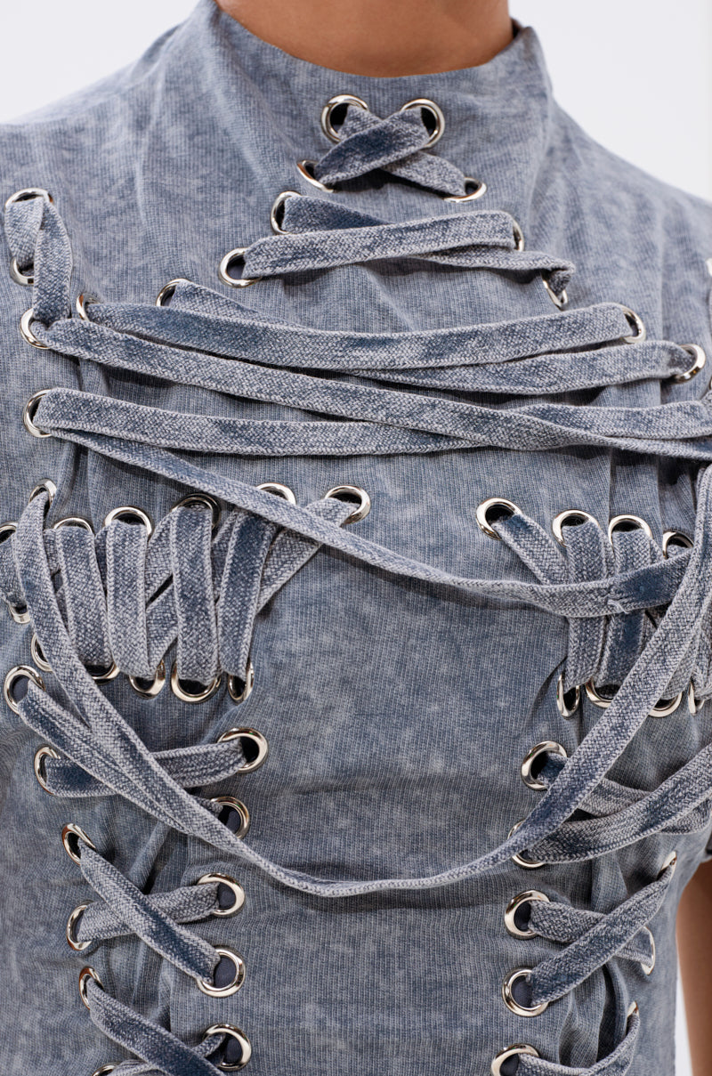 A close-up of fabric showing the intricate textures of the ABLE TO SEE ME STRAPPY TOP's deconstructed corset design—ideal for edgy streetwear or a bold look. 6