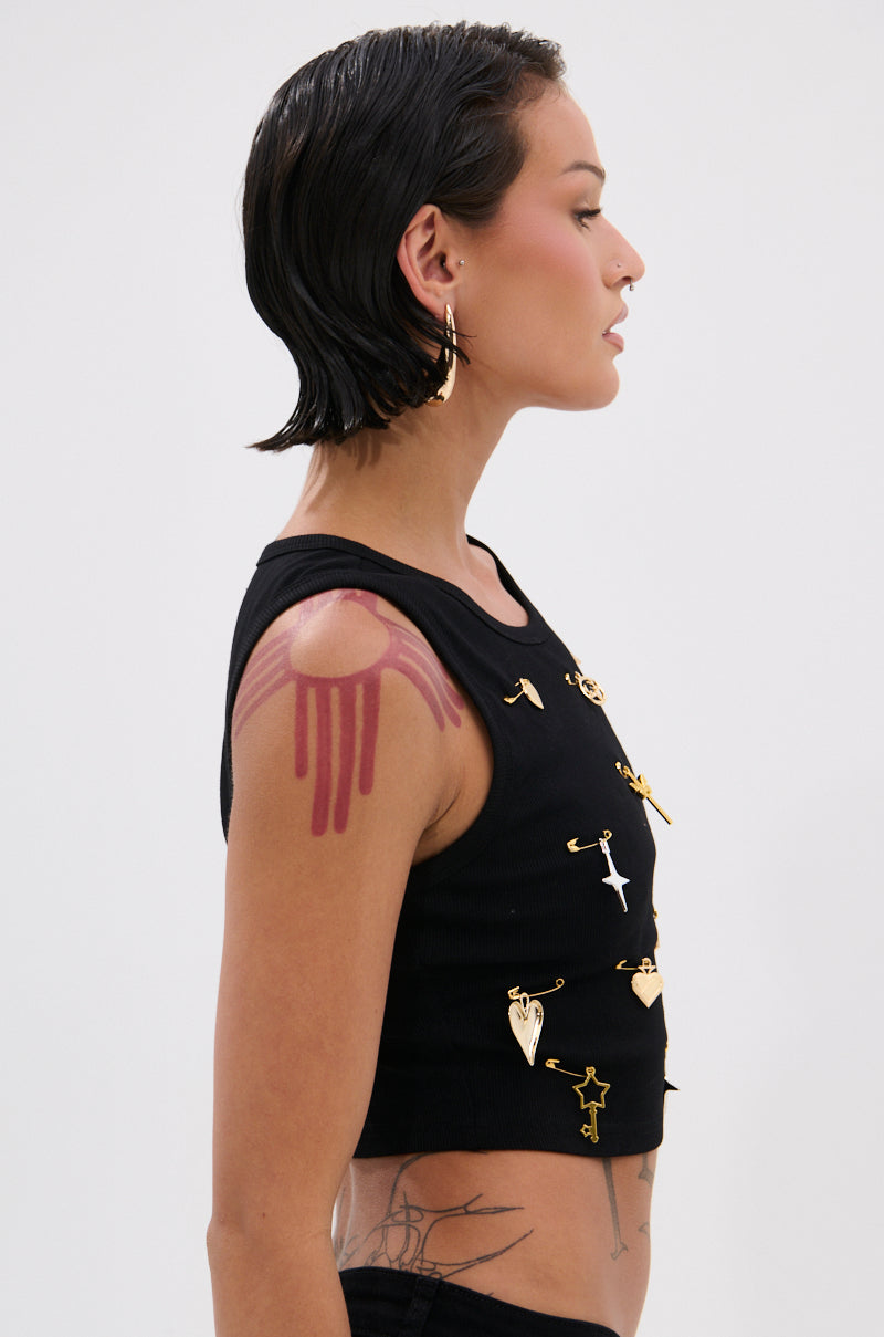 A woman with short, wet black hair wears the LOVIN' YOU EMBELLISHED TANK TOP with gold pins. Her left shoulder shows a red dripping paint design. She accessorizes with gold earrings and a nose ring against a plain white background. 2