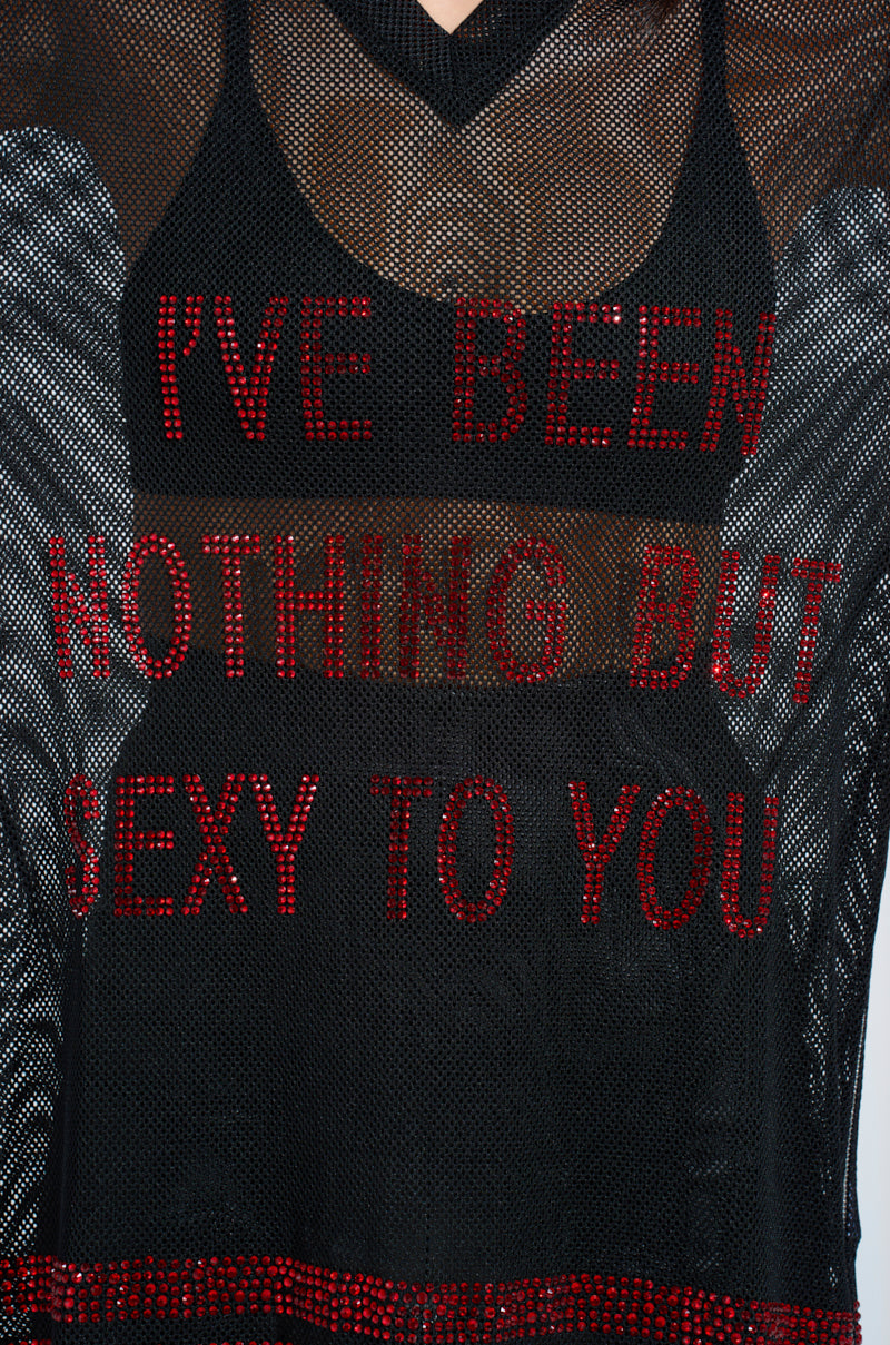 Close-up of the "I HAVE BEEN NOTHING BUT SEXY TO YOU JERSEY," a black mesh design featuring red sequin text and subtle rhinestone embellishments.