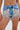 A close-up of a person wearing the DIVALICIOUS DENIM SHORT, high-waisted Western-style shorts with silver bead and sequin floral embroidery, rhinestone details, and beaded fringe along the hem.