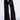 A person wearing the TRUE STORY SEQUIN PANT showcases a high-rise wide-leg silhouette adorned with shiny black sequins and complemented by a blue and white striped elasticized waistband. The pants are stylishly paired with black pointed-toe heels, all set against a pristine white background.