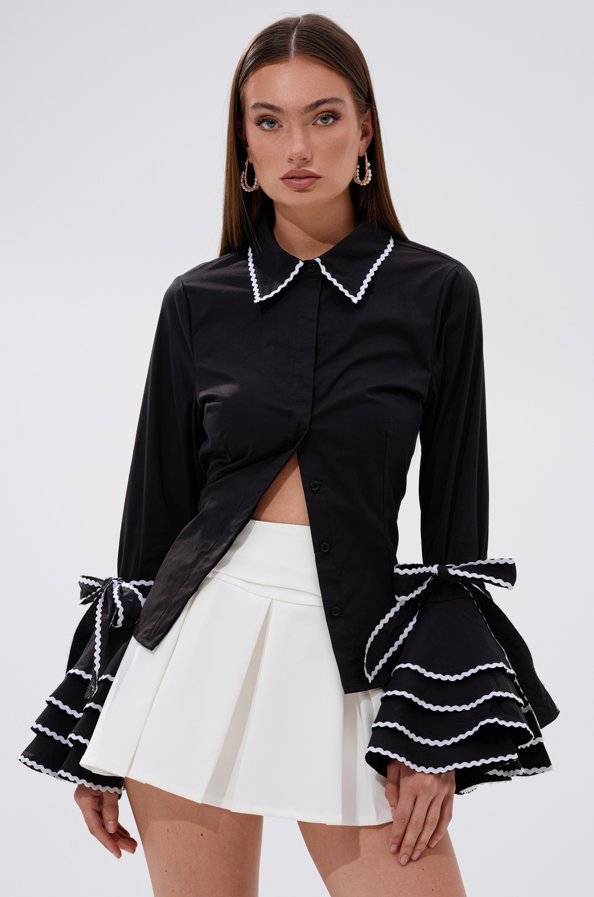 A woman wearing the BUSINESS ONLY BUTTON DOWN in black.