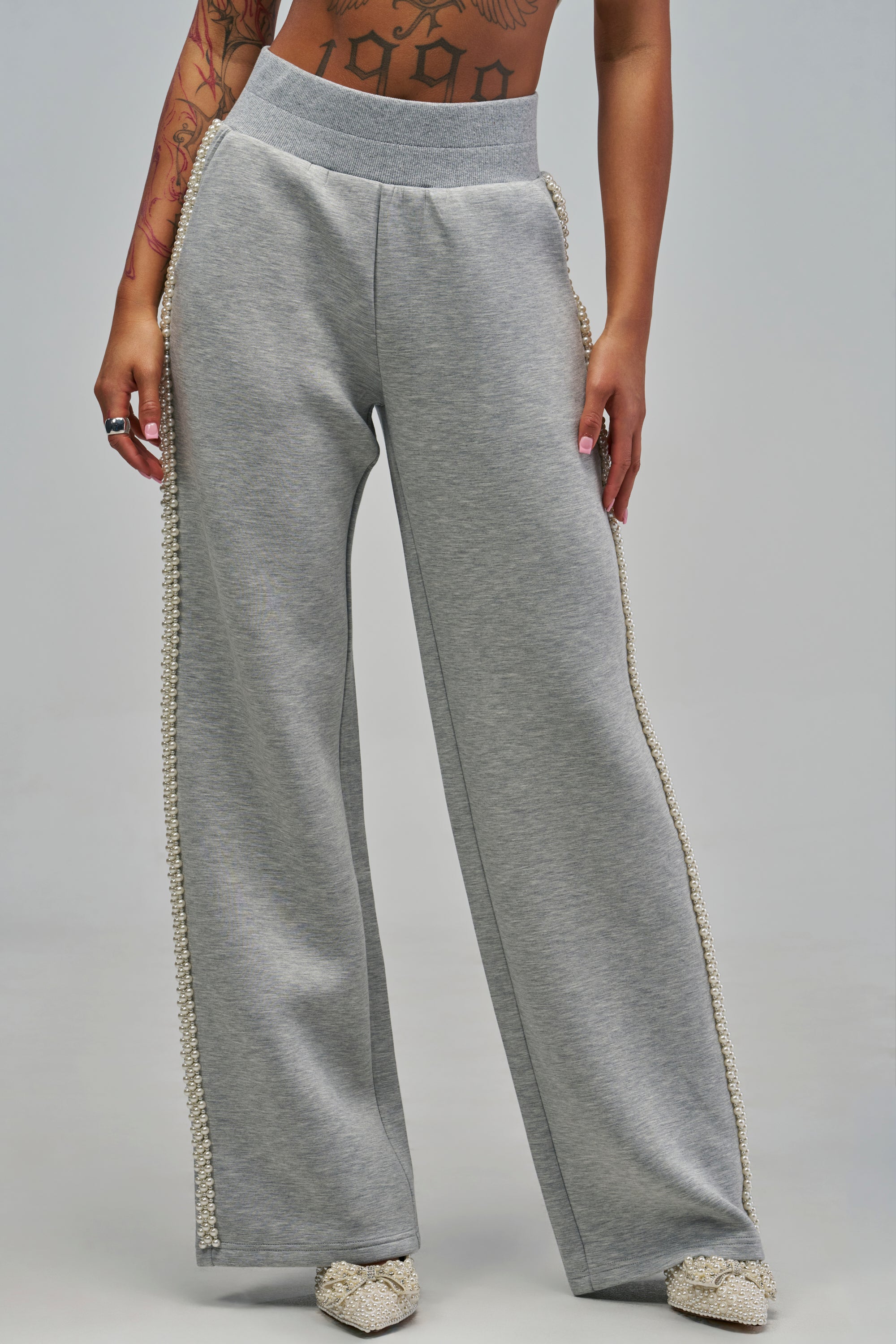Heather grey ALEXA SCUBA SWEATPANT wide-leg sweatpants featuring strings of pearls running down the outer seams and on the pointed-toe shoes.