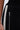 Close-up of the PEARL GIRL JOGGER in black, showcasing a vertical silver zipper and a decorative row of white pearls along the side. A hand rests near the fabric's edge.